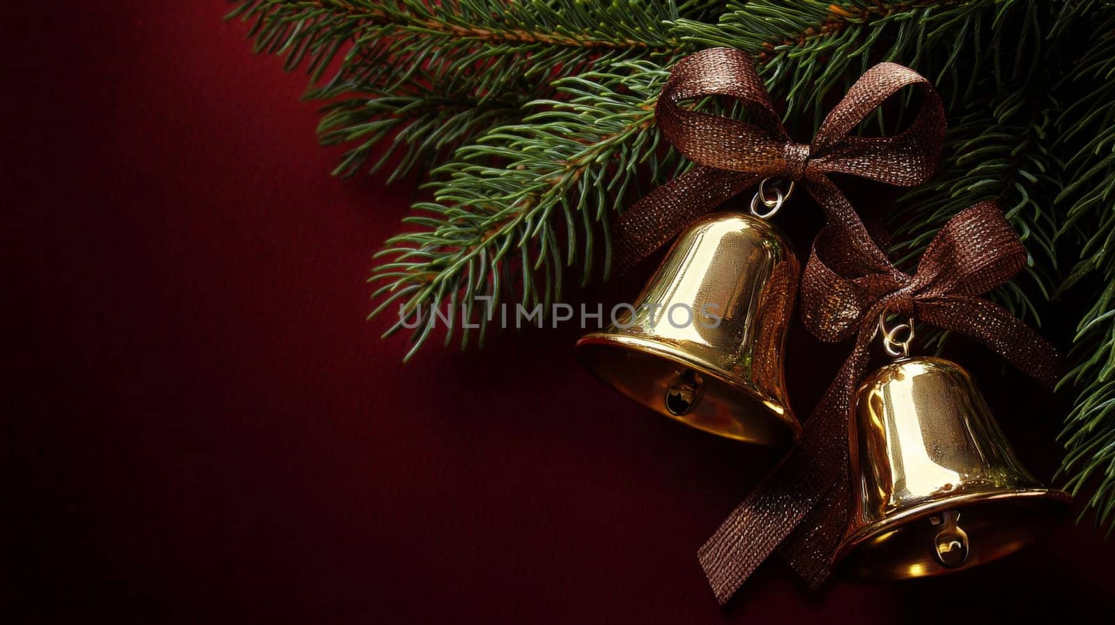 A close-up view of two golden bells adorned with a brown ribbon bow, hanging amidst lush green pine branches. Set against a vibrant red background, this festive composition exudes warmth, tradition, and the joyful spirit of the holiday season.
