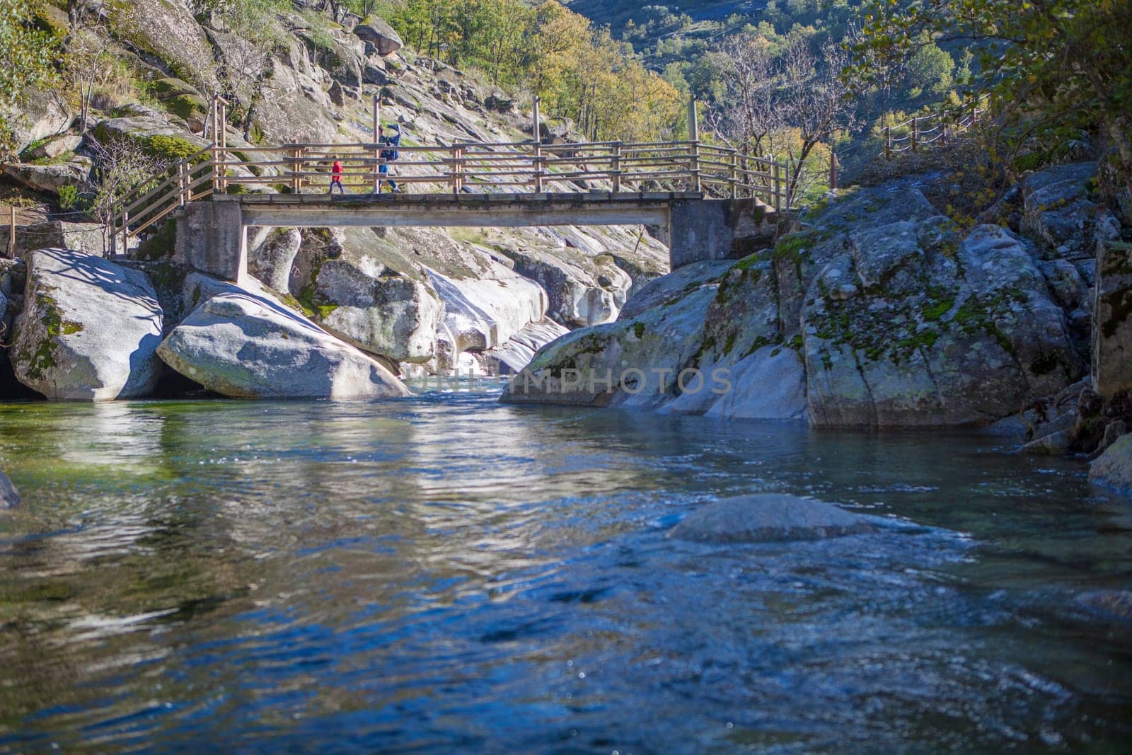Family crossing Los Pilones pedestrain bridge. Garganta de los Infiernos Reserve, Extremadura, Spain