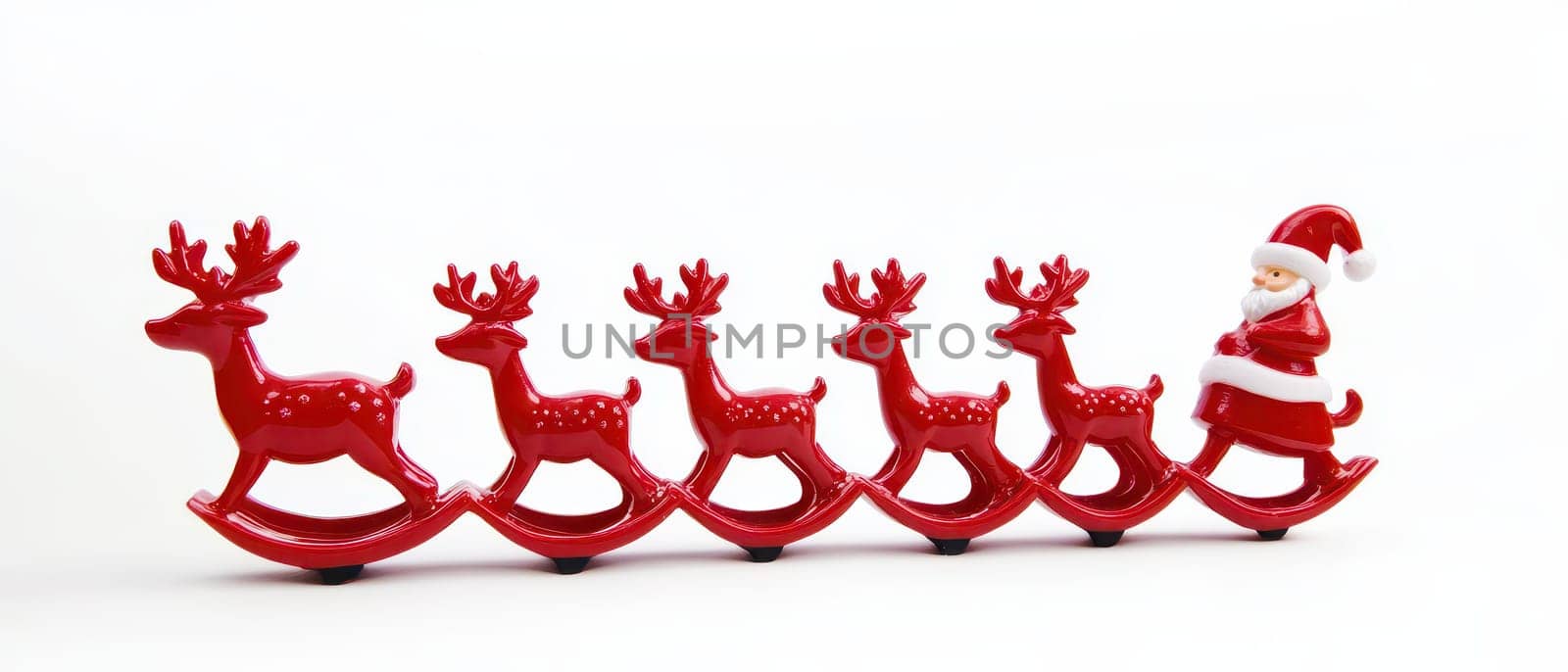 A cheerful Santa figure rides on a sleigh pulled by six red reindeer bringing a festive touch to holiday decorations.