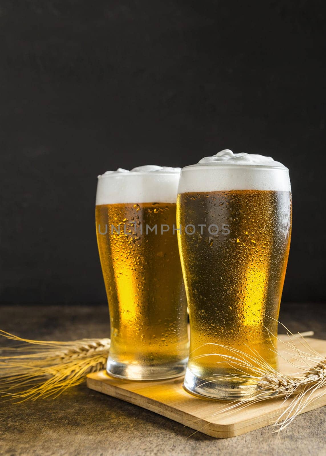 front view glasses beer with wheat