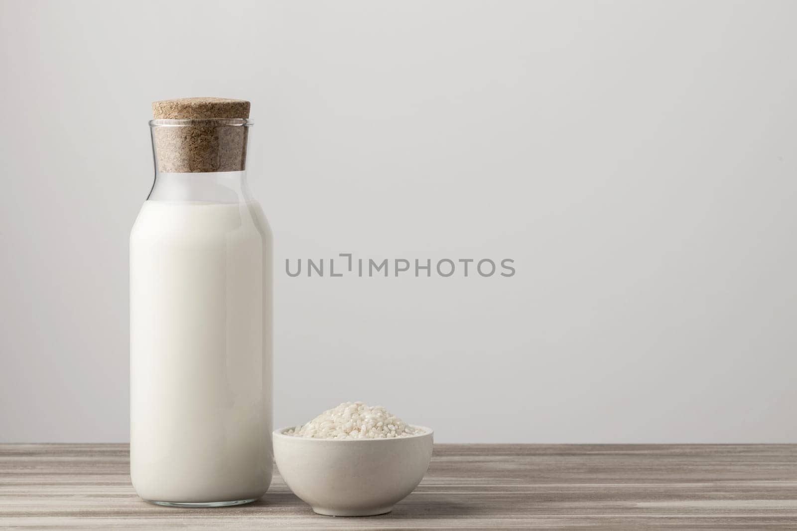 front view milk bottle with rice copy space