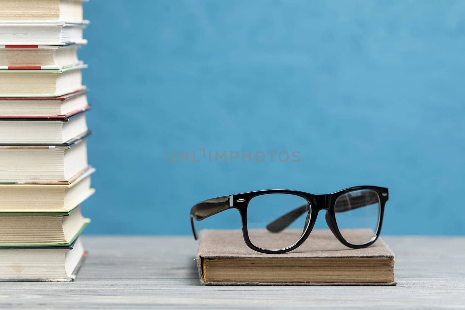 front view pile books with glasses