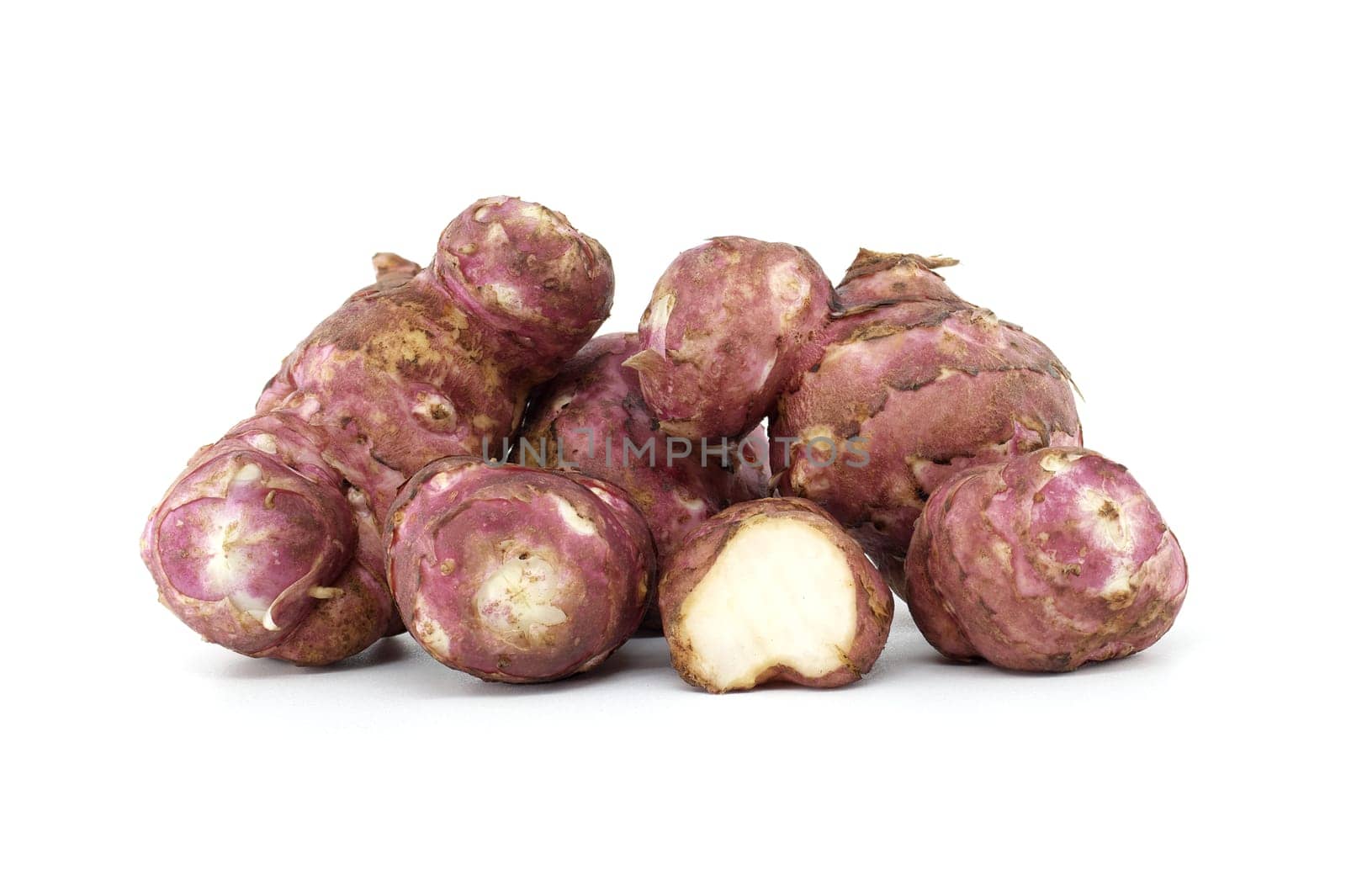 A group of fresh Jerusalem artichokes are shown against a white background, highlighting their texture and natural color. Ideal for food, health, and organic nutrition themes