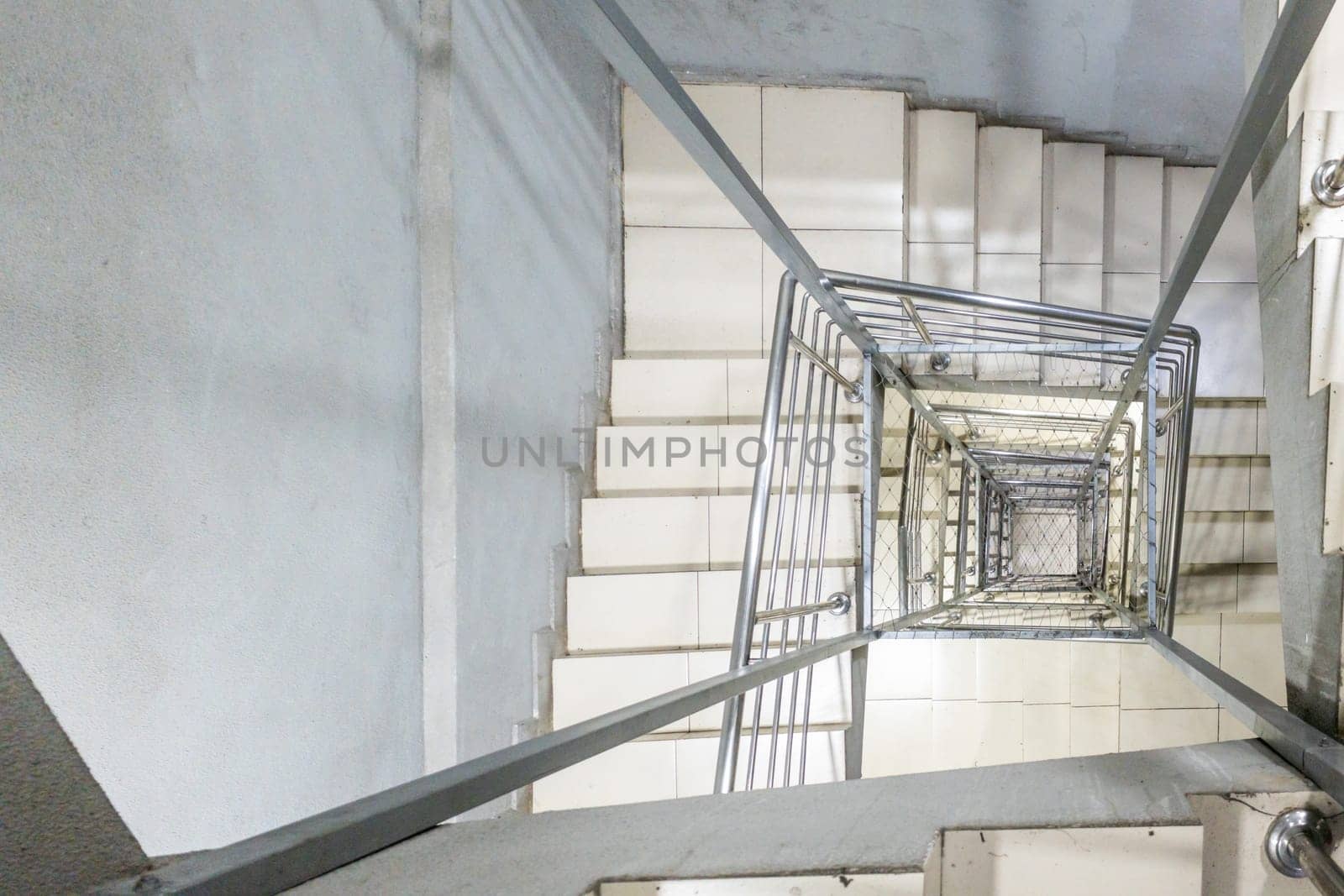 Generic modern square staircase shaft with steel net for fall safety
