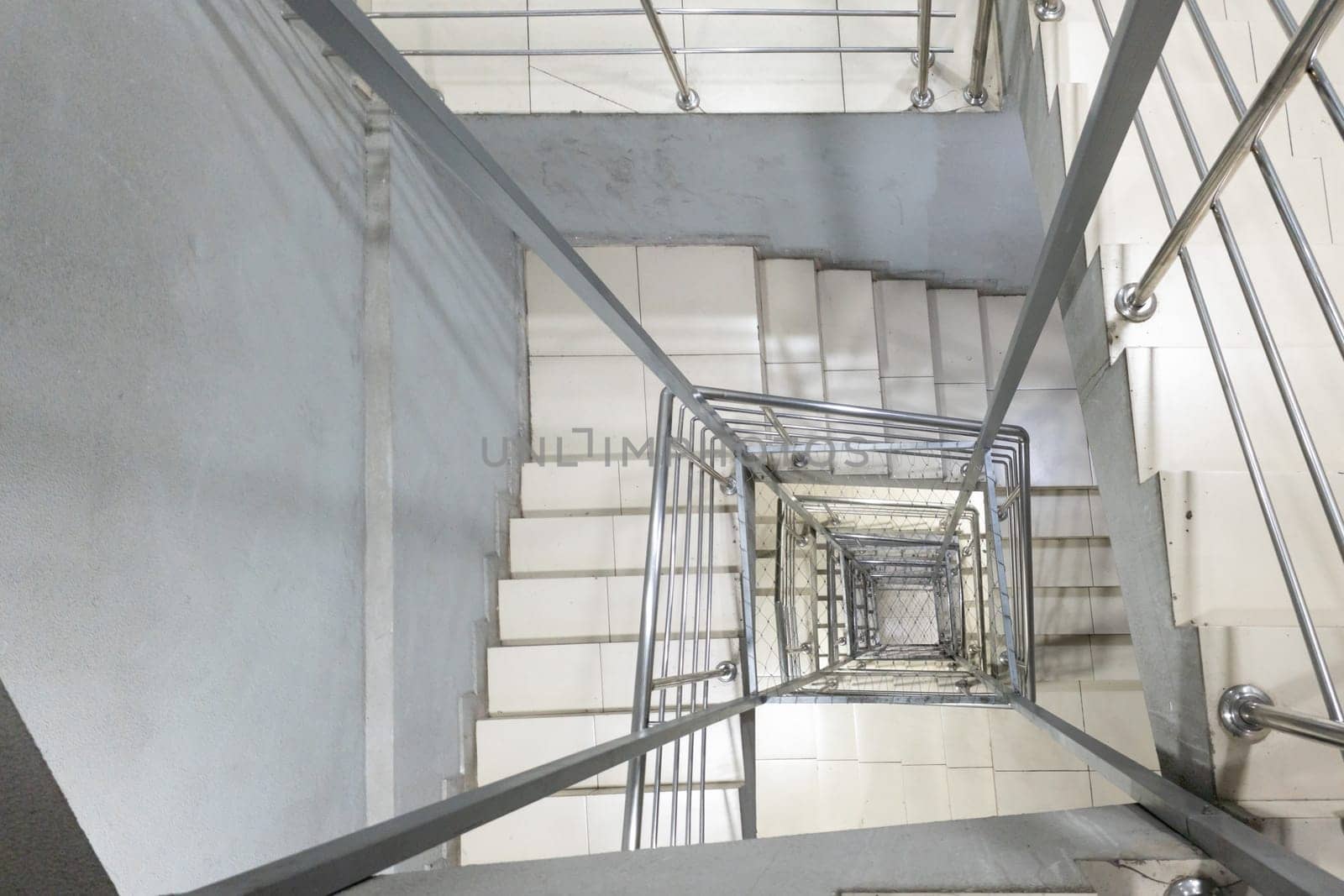Generic modern square staircase shaft with steel net for fall safety