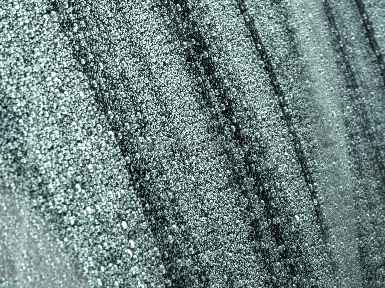 water drops on car window - full-frame closeup background with selective focus, outside view