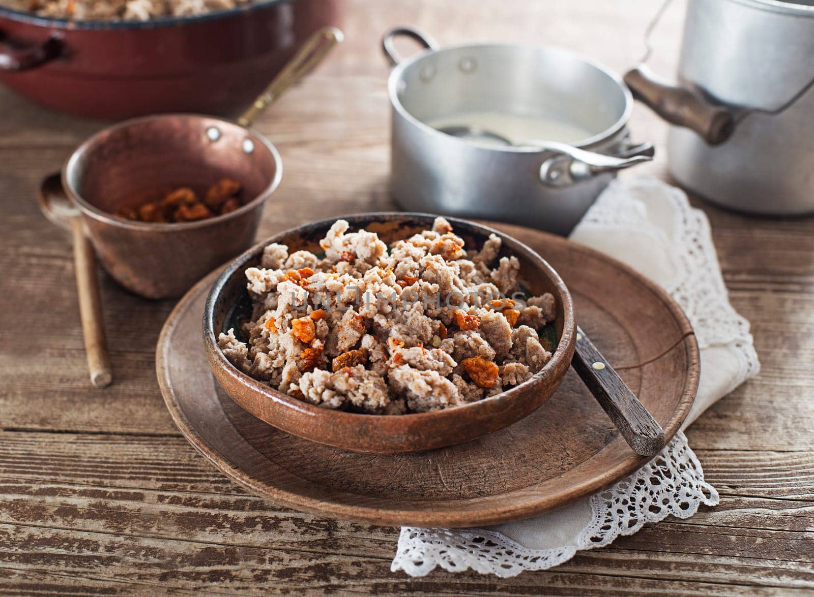 Slovenian traditional dish buckwheat mush served with pan-fried pork cracklings and lard and bowl warm milk