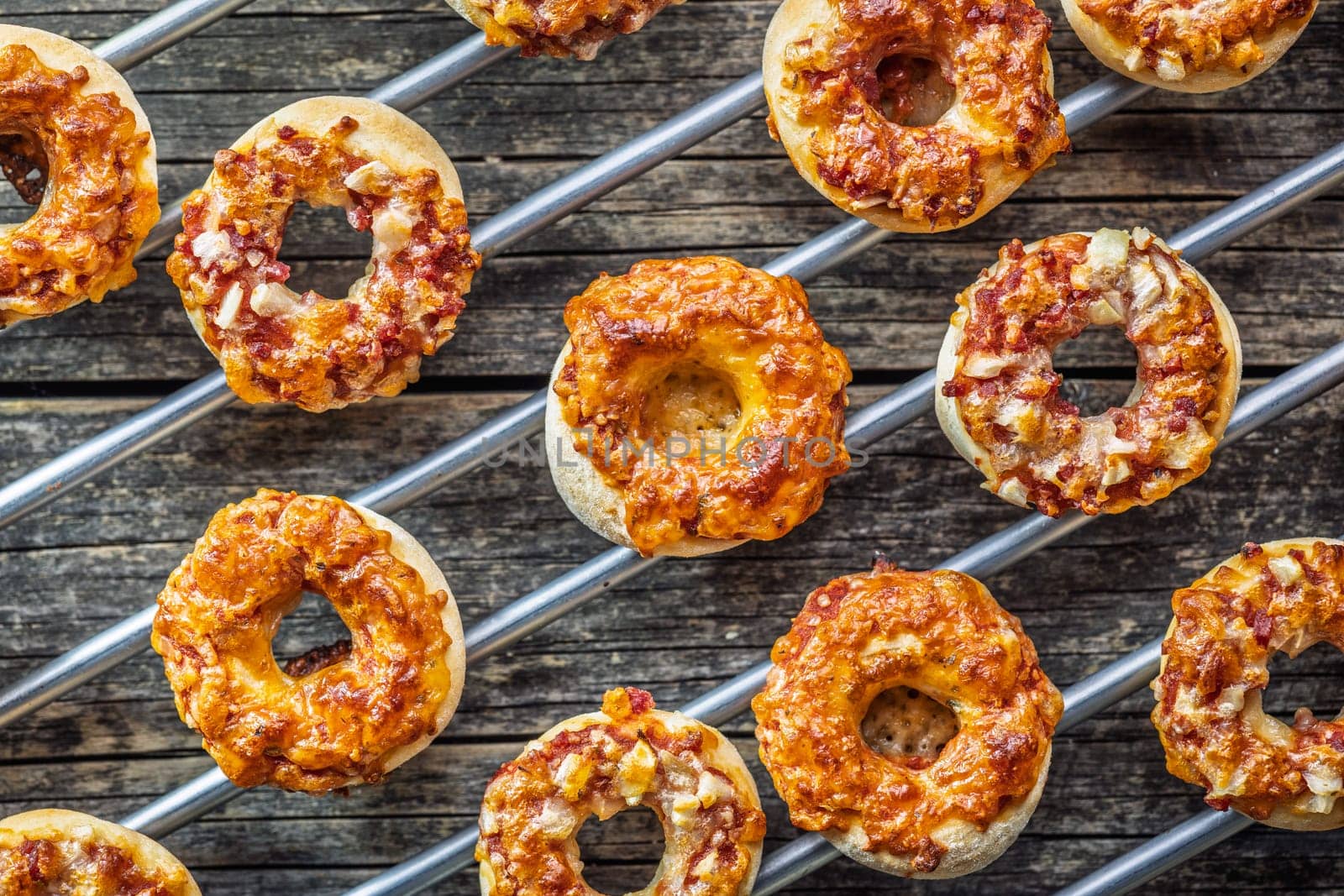 Mini pizza bagels on a wooden table. Top view.