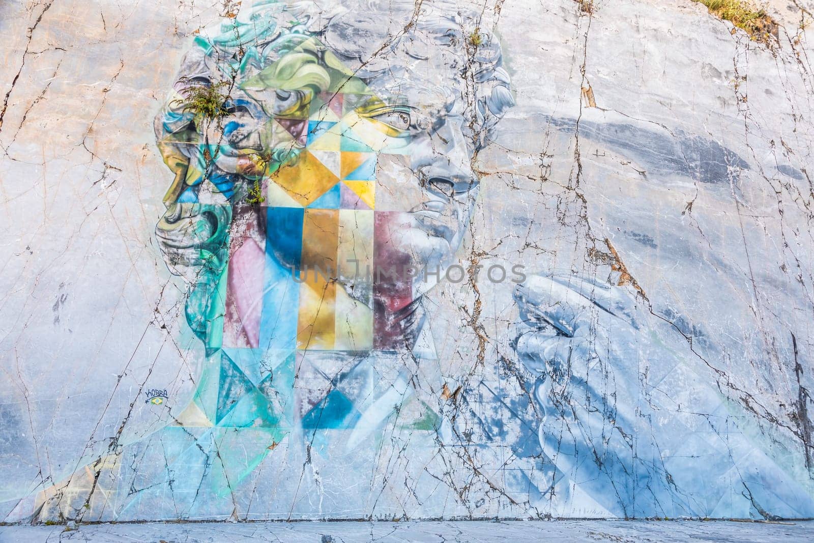 Colonnata di Carrara, Italy - 08 August 2024: the famous David murales by Kobra, inspired by Michelangelo. Street art on white marble, made in 2017.