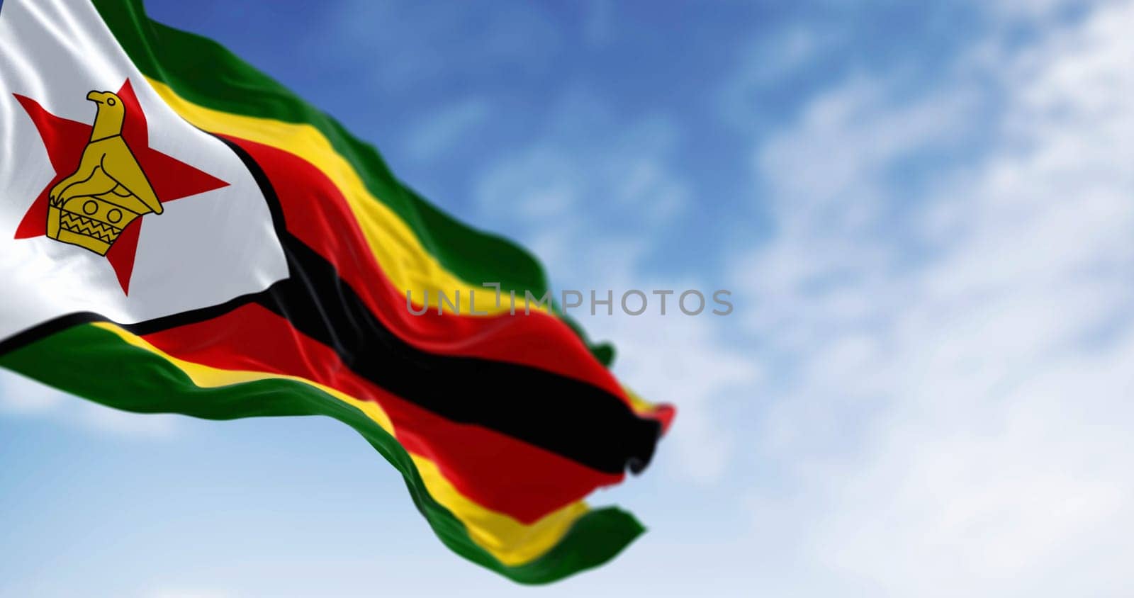 Zimbabwe national flag waving. Horizontal stripes of green, yellow, red and black. White triangle with a red star and yellow bird. 3D illustration render. Selective focus. Rippled textile background