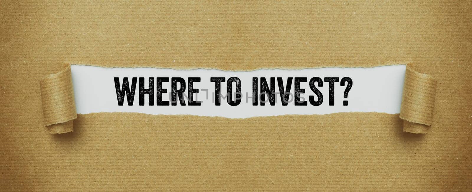 Torn paper revealing the words Where to invest