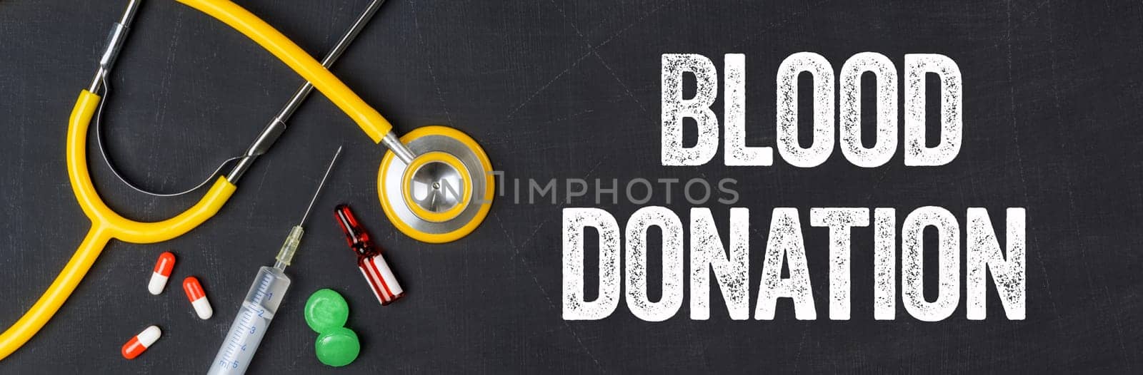 Stethoscope and pharmaceuticals on a blackboard - Blood donation
