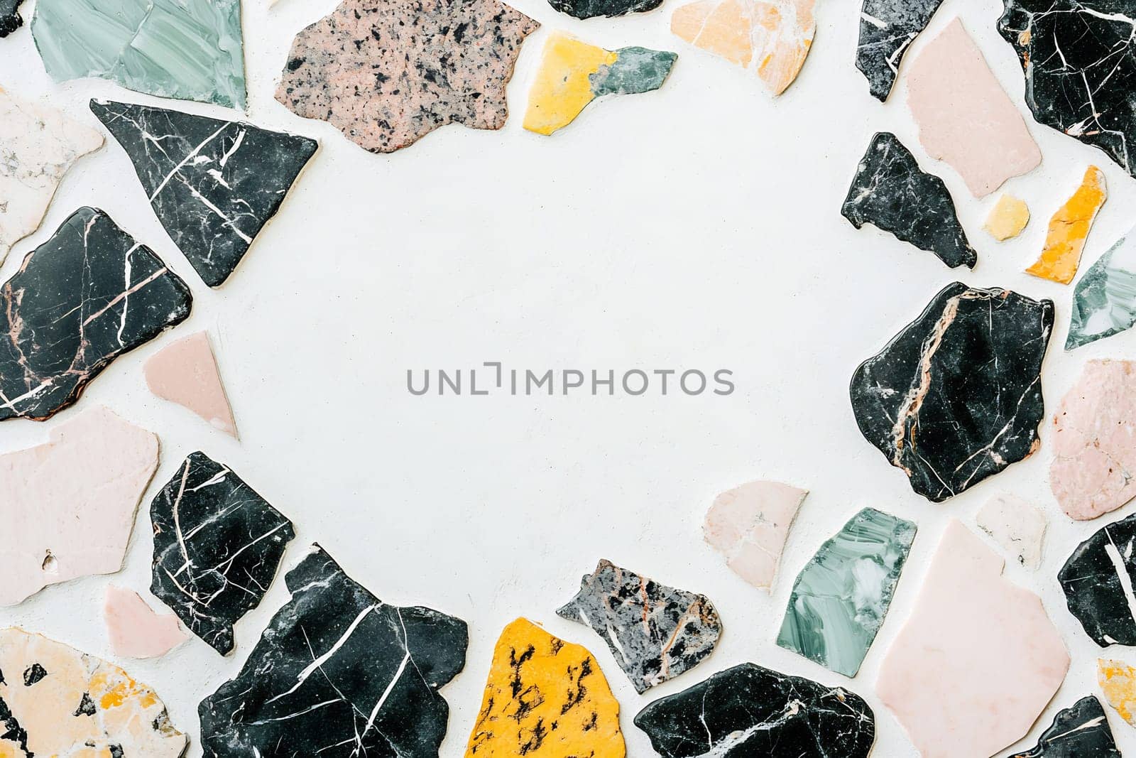 Various shaped stones in shades of black, pink, green, and yellow create a vibrant mosaic border around a light center.