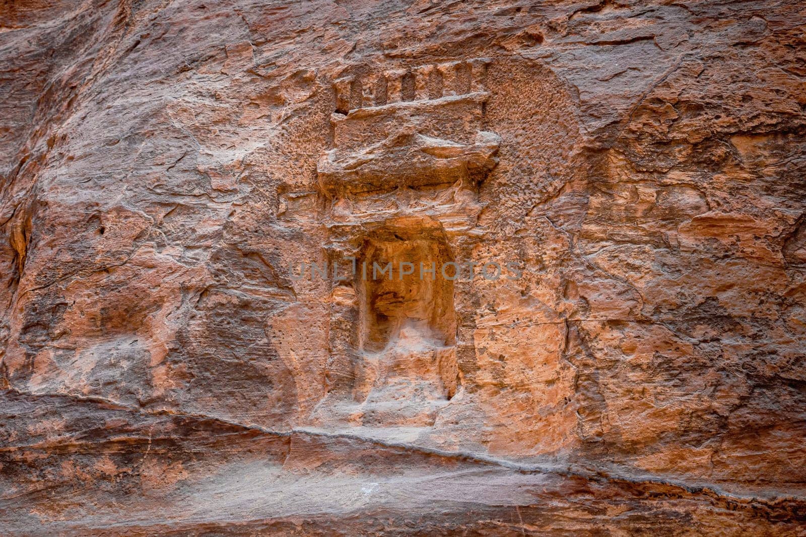 Arched niche with betylene on the wall of Siq canyon in Petra, Jordan.. Horizontally.