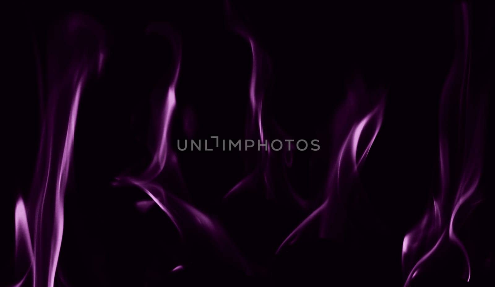 Various flames from a fire in purple against a black background