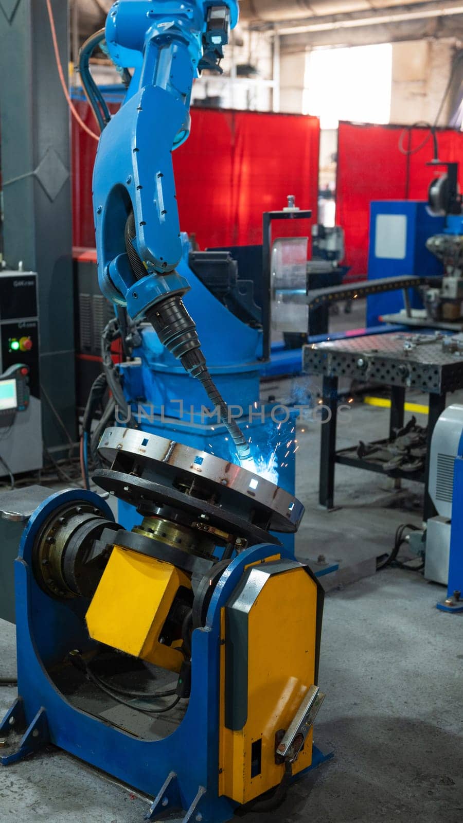 Automatic Industrial welding robot in a modern factory in operation.