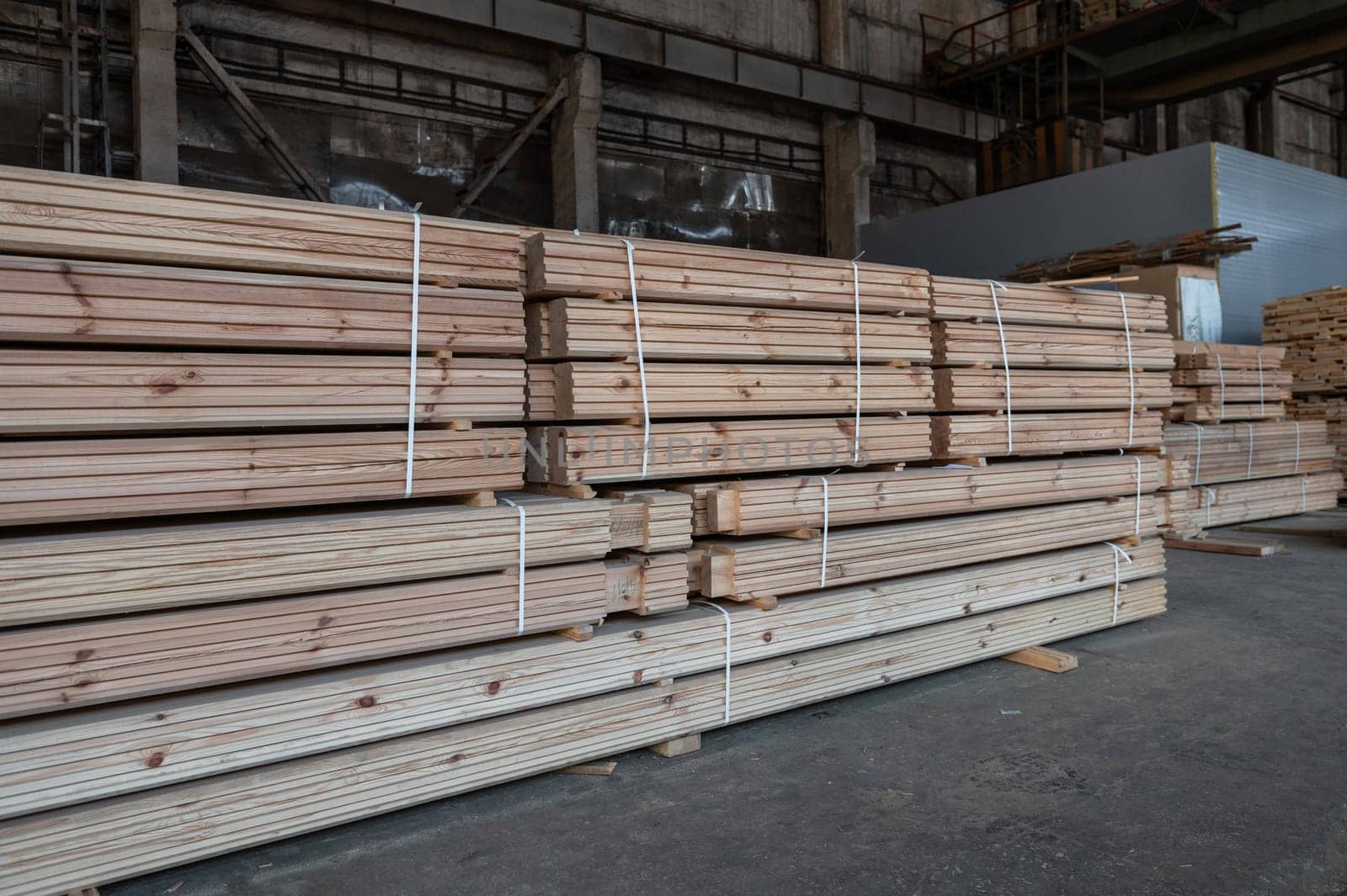 Stacked wooden planks close-up at lumber warehouse. Wood industry concept