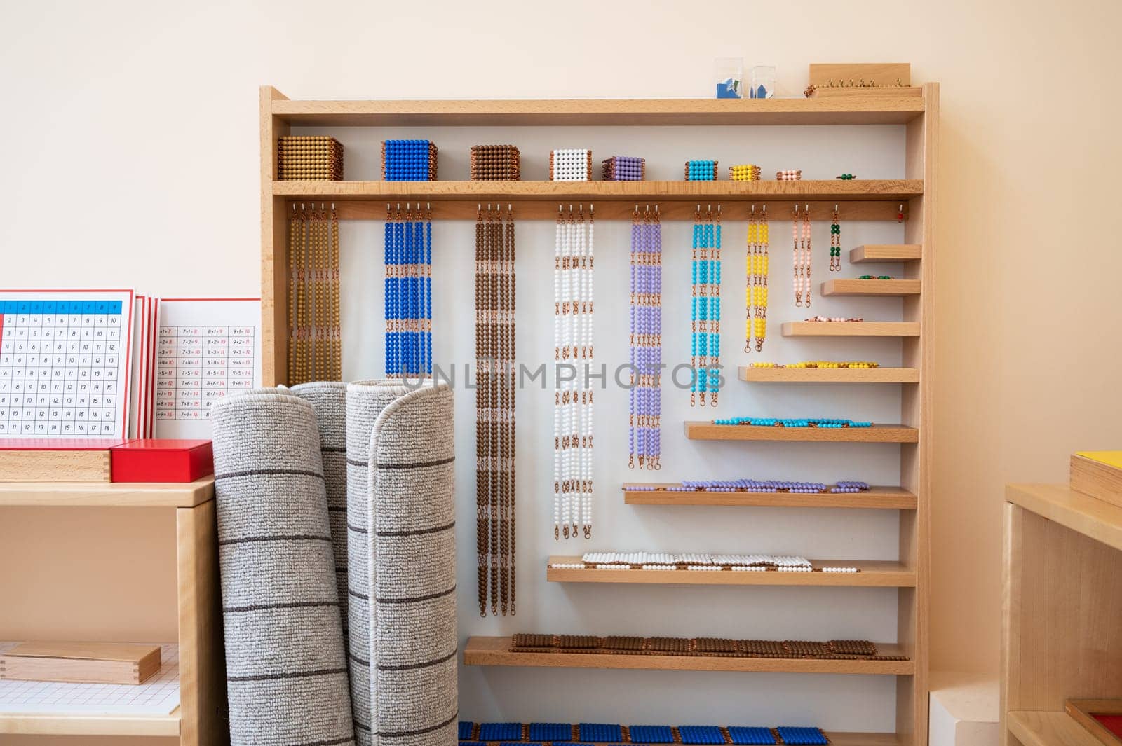 Montessori material. Wooden shelf with materials for Montessori studies