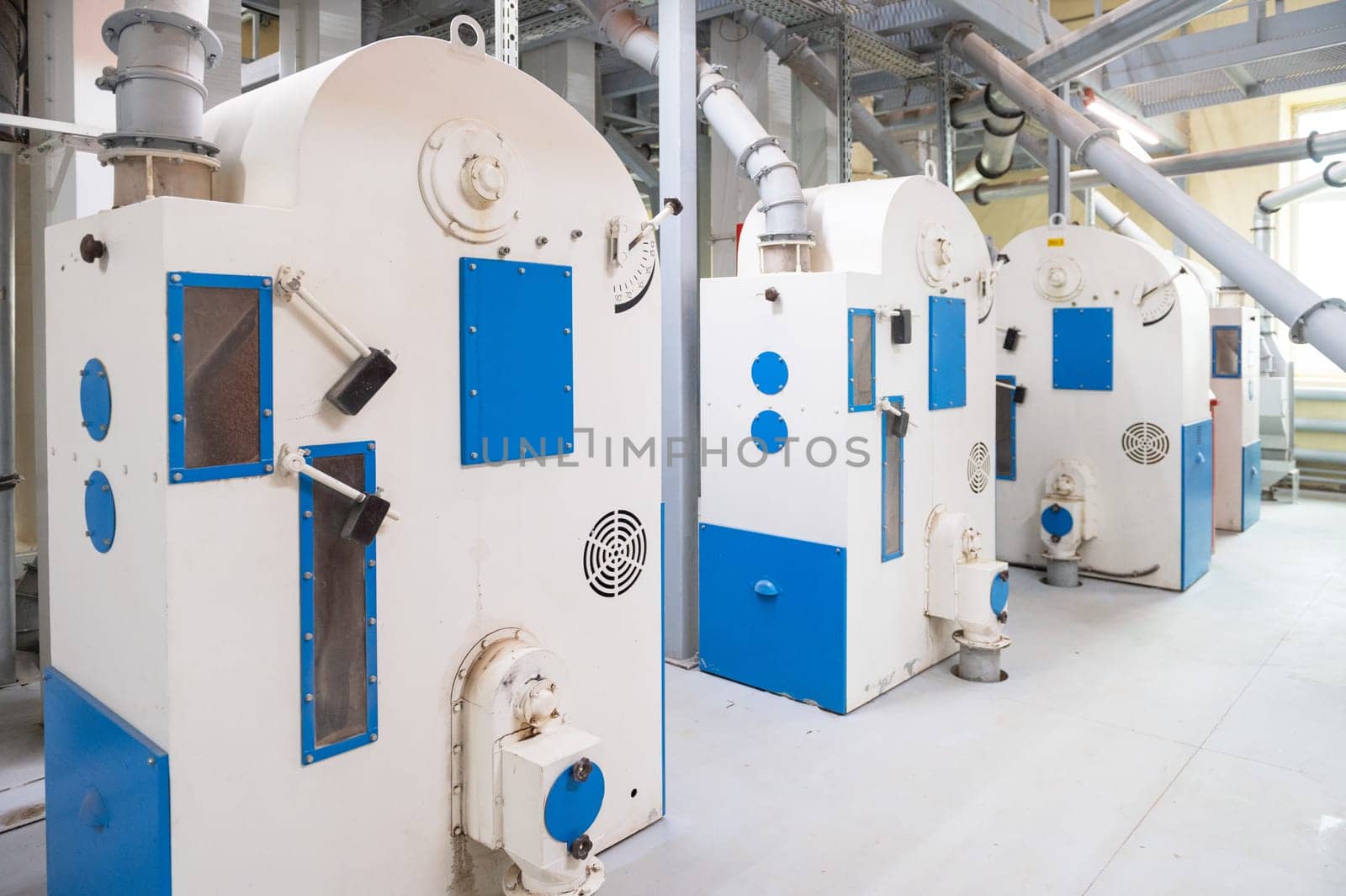 Roller deck machines for husking buckwheat grain, operating in a modern processing facility.