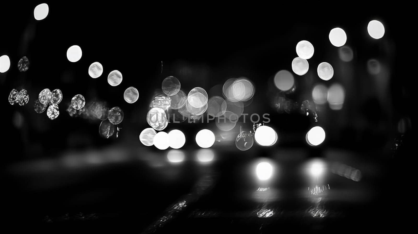 A black and white abstract background featuring blurred elements and a subtle glowing effect. The interplay of light and shadow creates a mysterious and ethereal atmosphere, highlighting the contrast between the dark and illuminated areas.