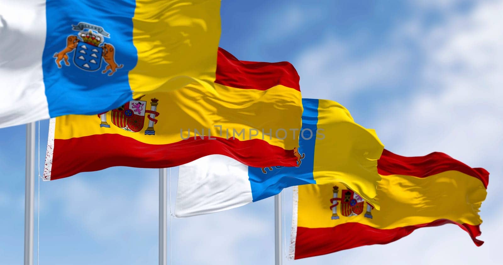 Canary Islands and spanish flag waving in the wind on a clear day. Spanish autonomous community. 3d illustration render. Selective focus. Close-up. Rippled textile