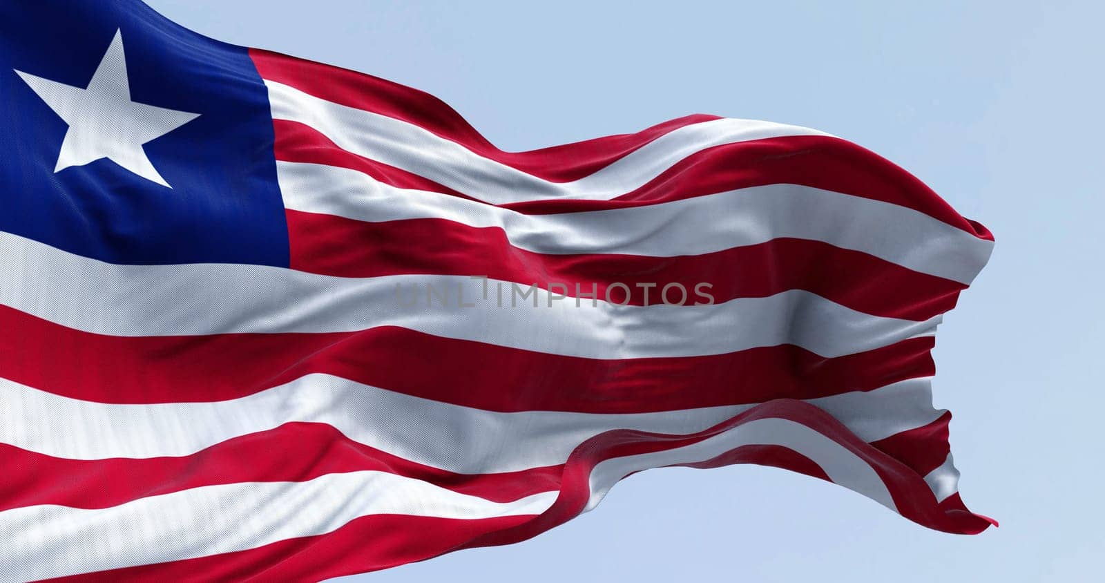 National flag of Liberia waving on a clear day. Red and white horizontal stripes that change color and a white star on the blue square in the canton. 3d illustration render. Rippling fabric