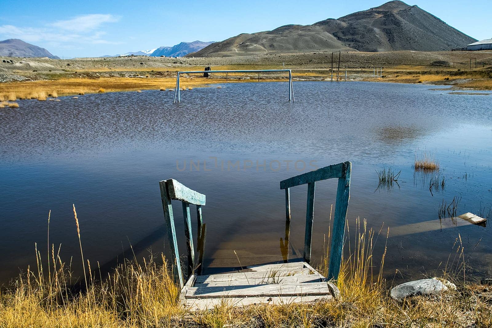 An old broken pier on the shore of the lake. Altai.