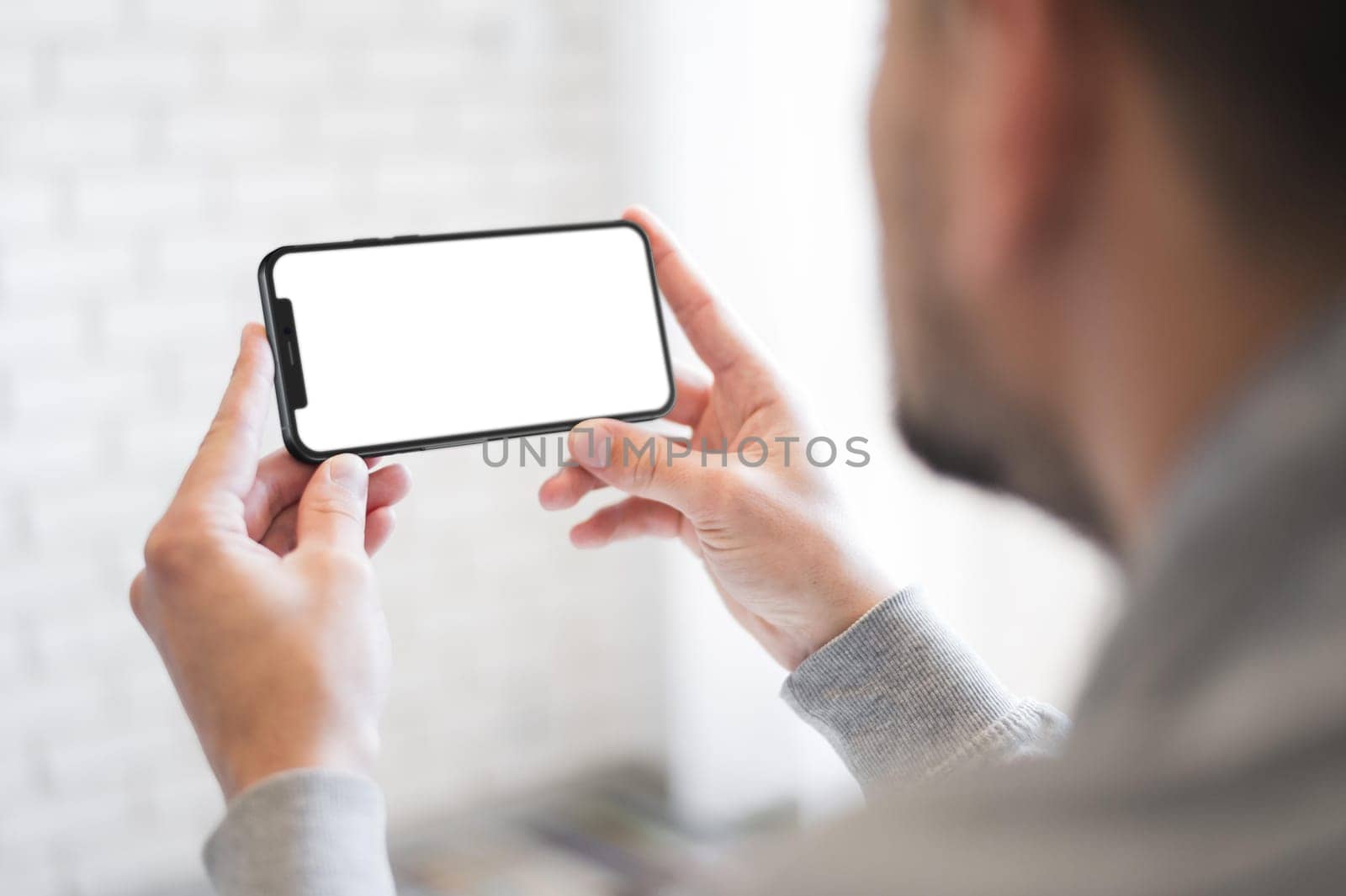 close up man holding smartphone