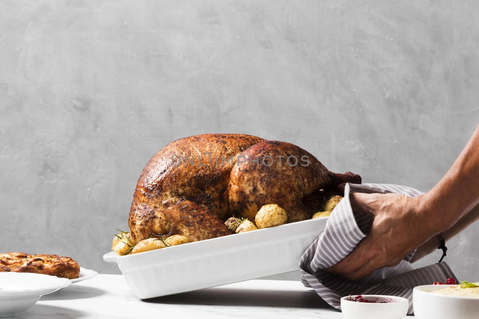 close up hands putting turkey on table