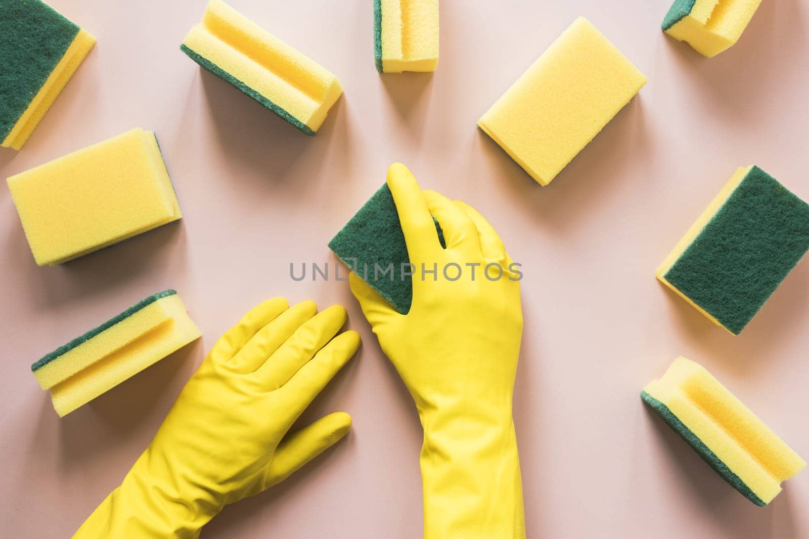 close up person with yellow gloves sponges