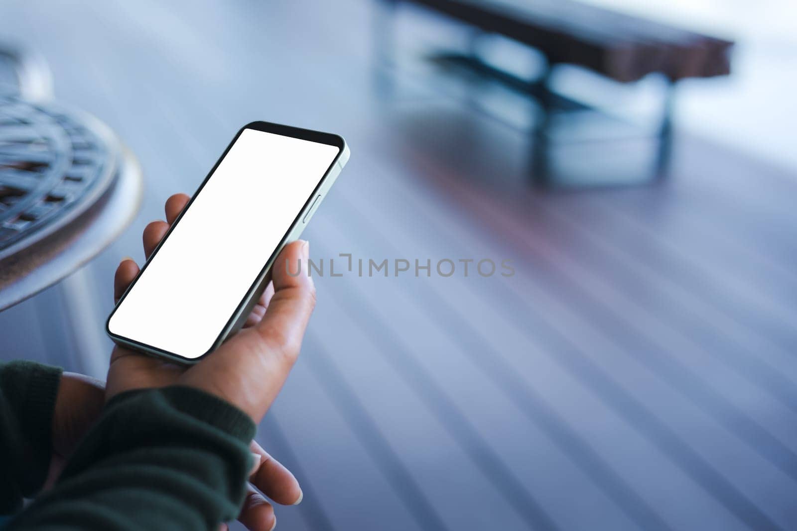 Business woman hand holding smartphone with white empty screen in hand, Smartphone mockup for online shopping, Booking and banking concept, Online education or online business with copy space.
