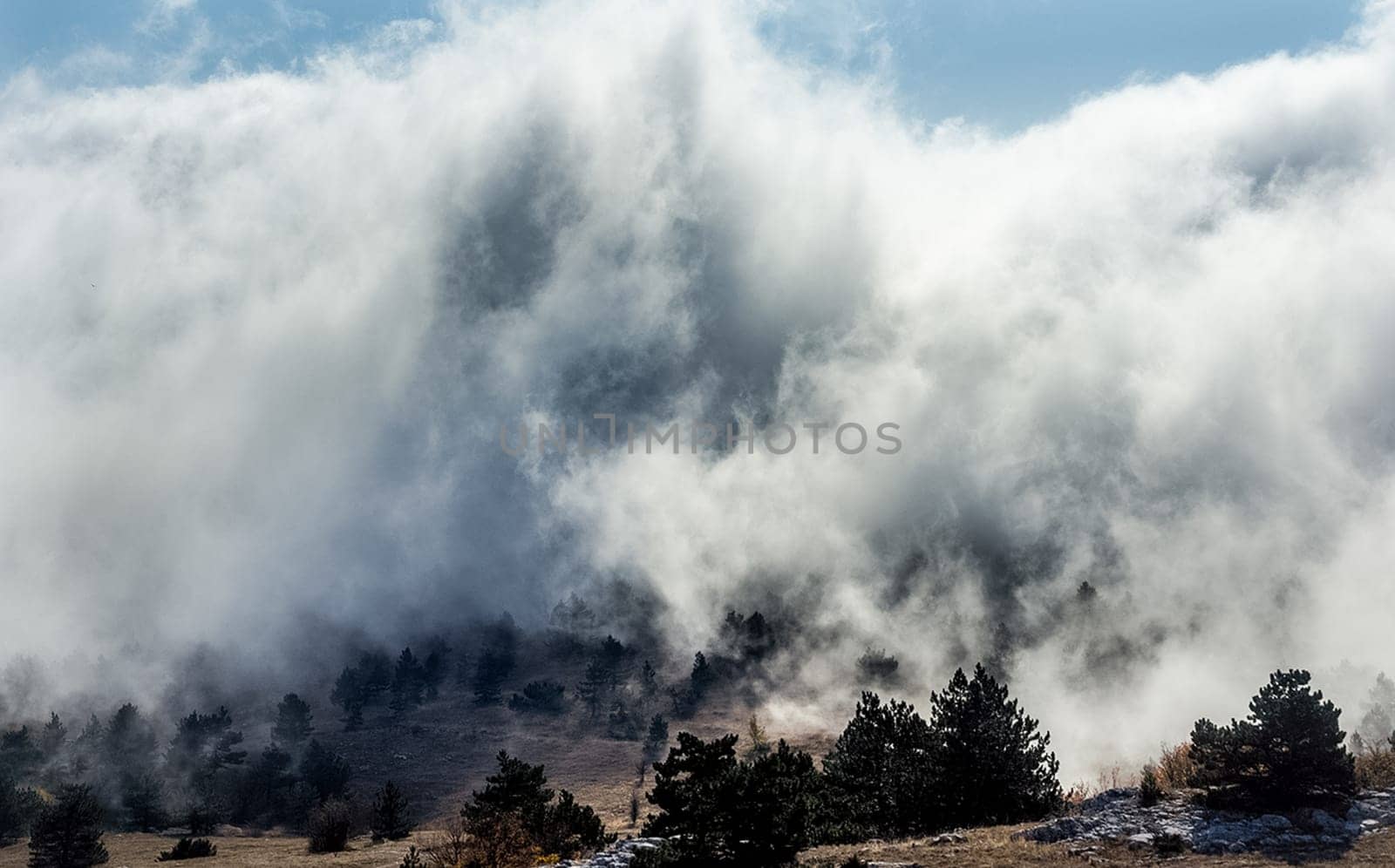 Low clouds over the valley, view from the mountains. Low clouds.