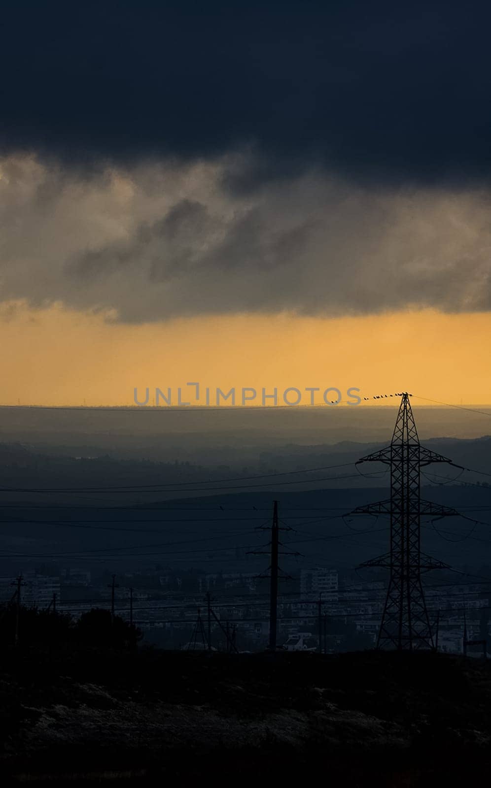 Dawn in the mountains of Crimea. A light haze of mist over the mountains and rays of the sun through the clouds.