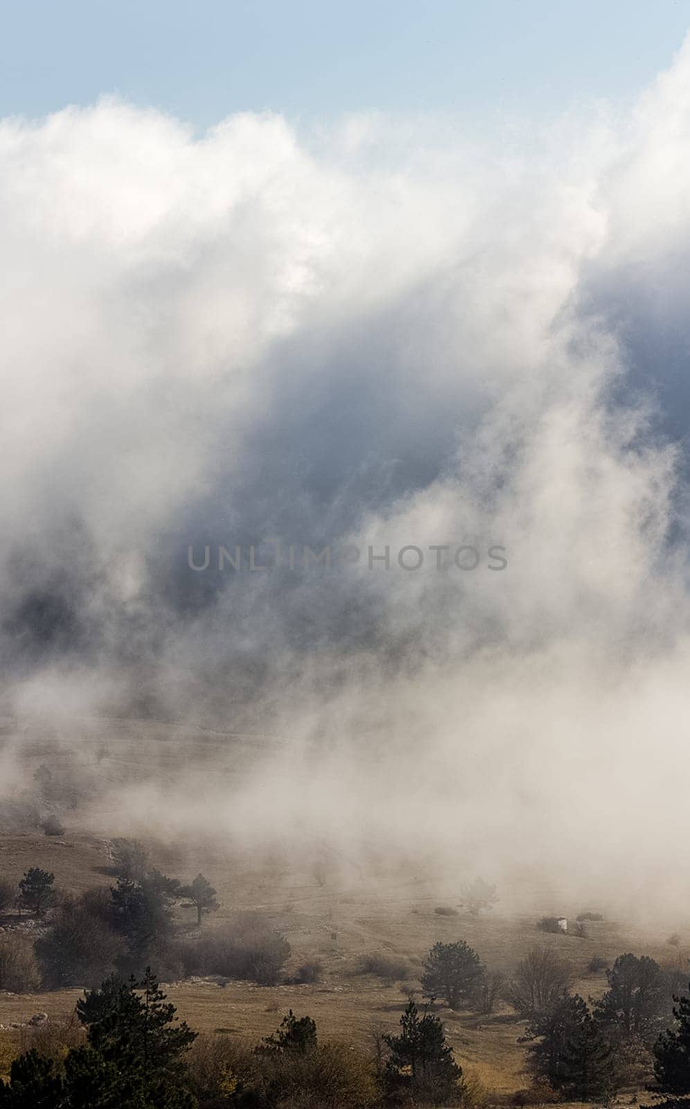 Low clouds over the valley, view from the mountains. Low clouds.
