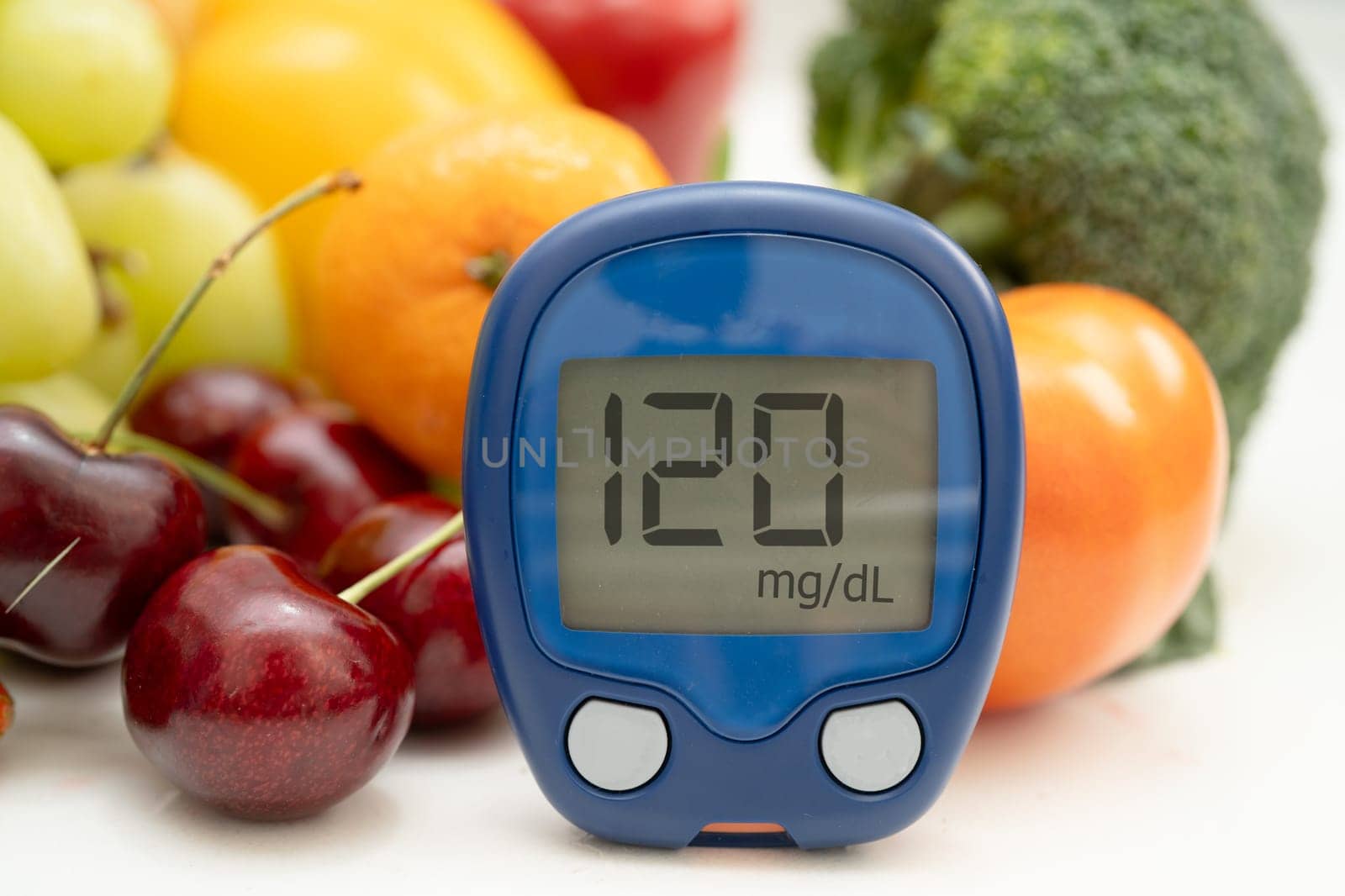 Glucose meter with vegetable and fruit for check sample blood sugar level to treatment diabetes.