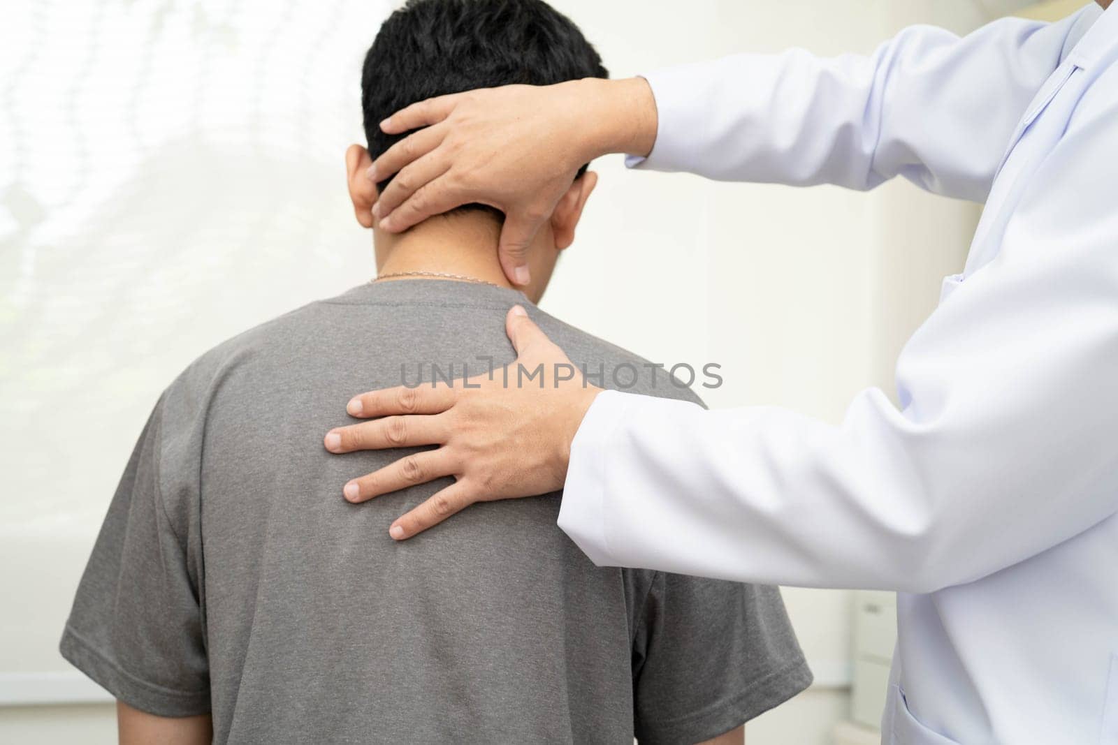 Physical therapy, Asian therapist doctor treat perform pain young man in hospital.
