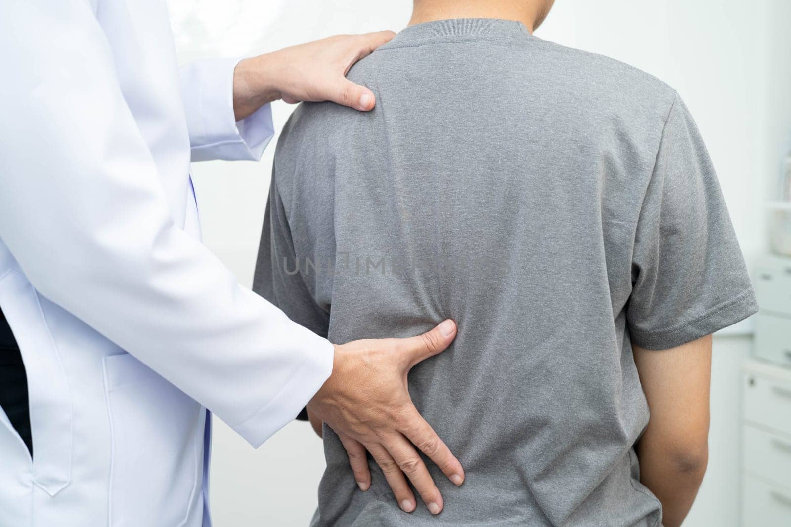 Physical therapy, Asian therapist doctor treat perform pain young man in hospital.