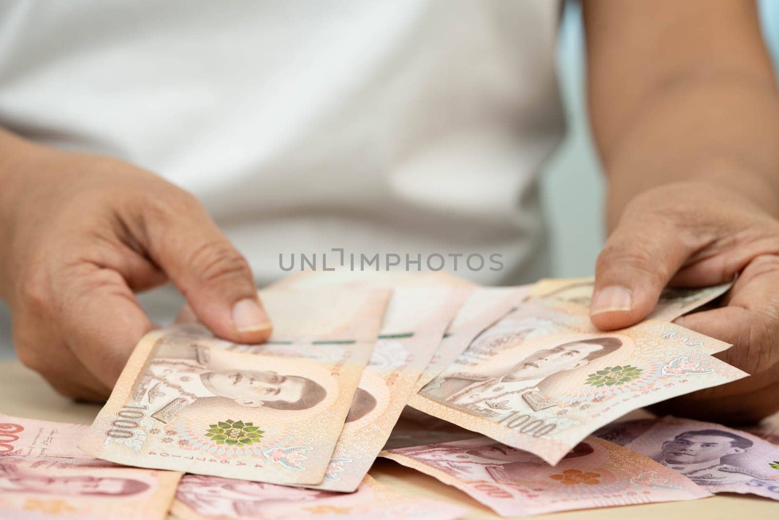 Asian woman counting Thai baht banknote money, investment economy, accounting business and banking.