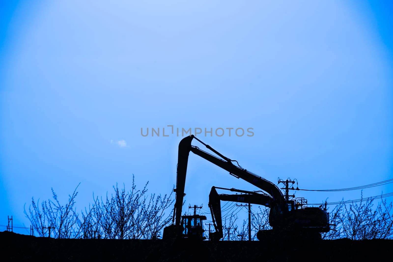 Power shovel and grassland of the silhouette. Shooting Location: Sendai, Miyagi Prefecture