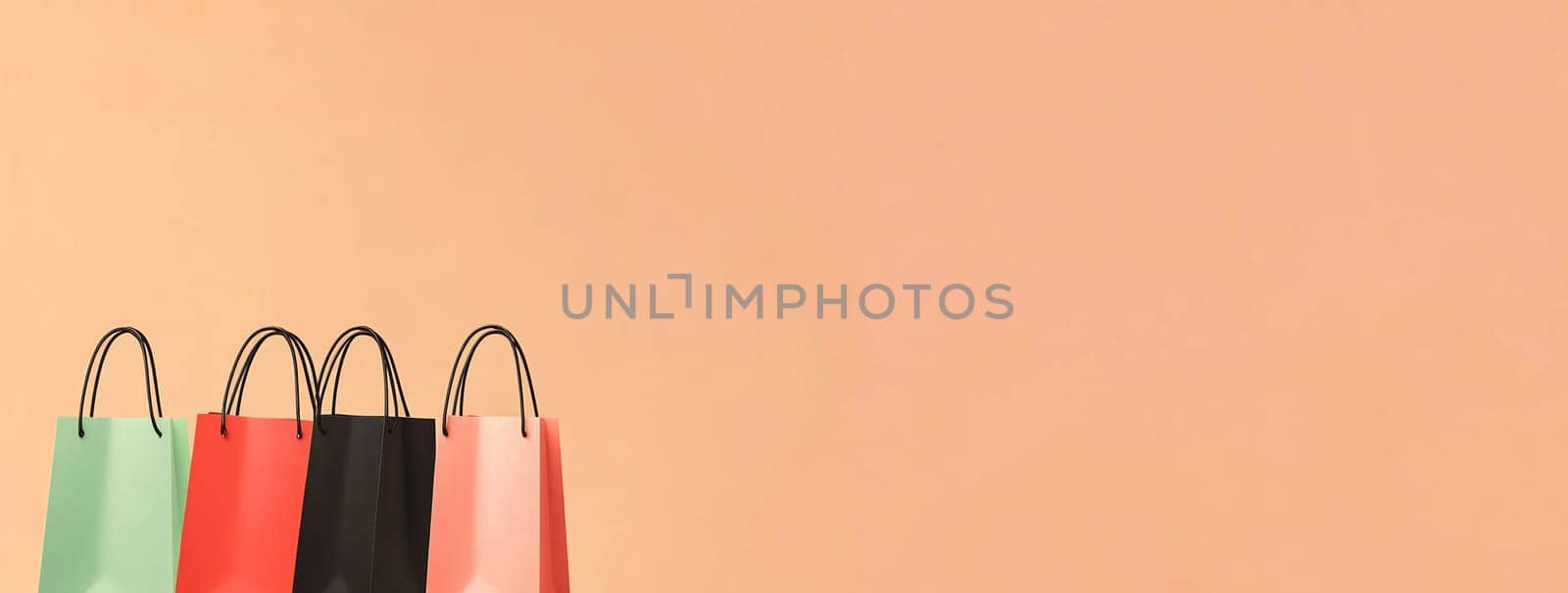 A collection of vibrant shopping bags in various colors lined up against a soft peach backdrop, showcasing a retail or gift shopping theme.