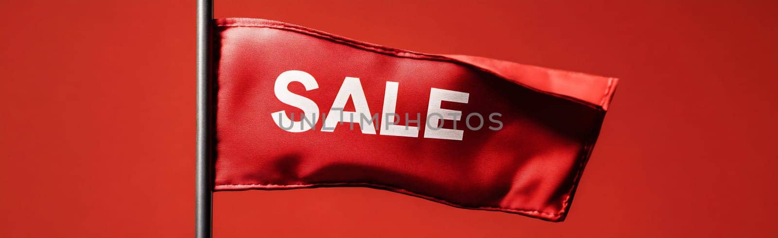 A vibrant red flag with the word sale visibly displayed flutters against a bold red background, attracting attention effectively.