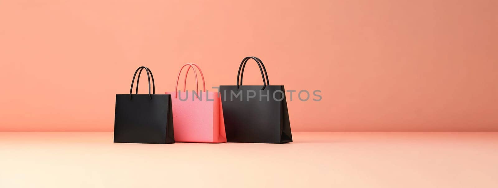 Three shopping bags in pink and black arranged against a soft peach background, showcasing modern design and retail themes.