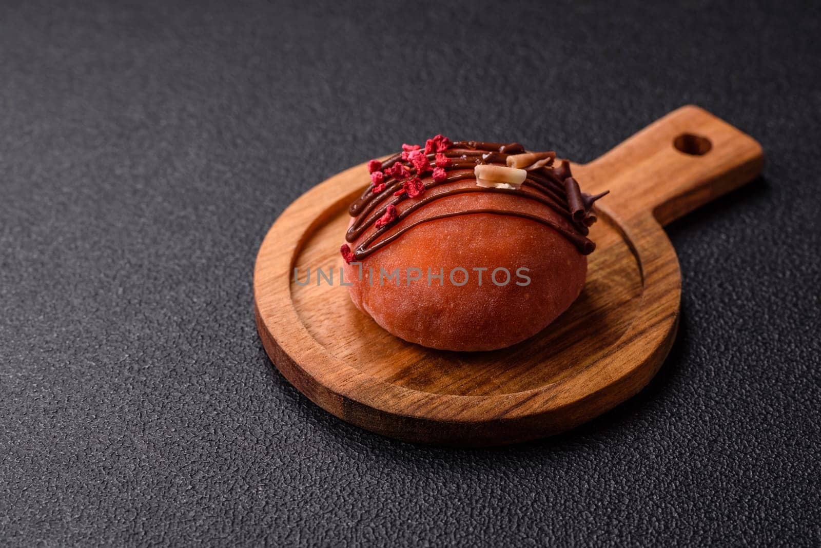 Delicious colorful asian mochi sweets with rice dough shell and fruit filling on dark concrete background