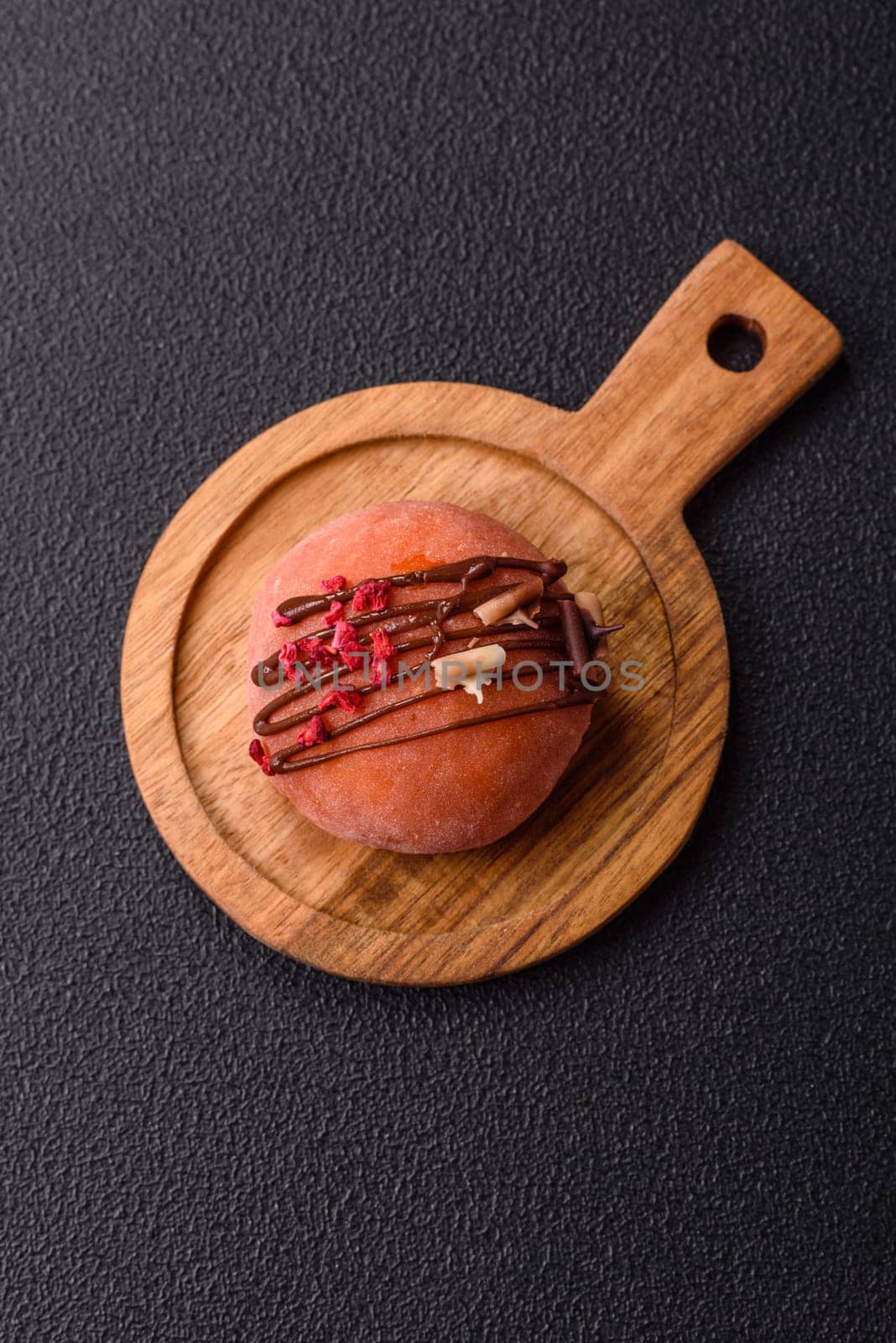 Delicious colorful asian mochi sweets with rice dough shell and fruit filling on dark concrete background