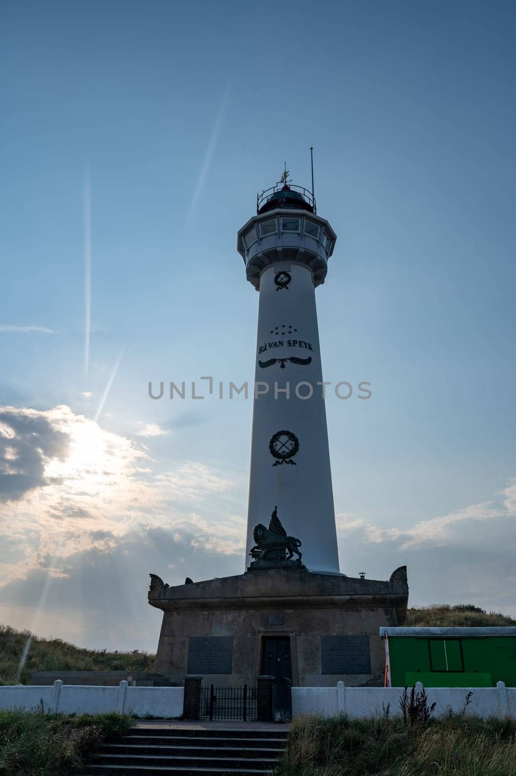 The approx. 28 m high white lighthouse J.C.J. van Speijk in Egmond aan Zee, North Holland, Netherlands at sunset