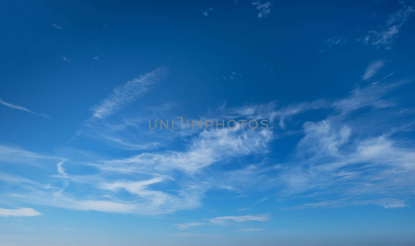 Clear Blue Sky with Whispy White Clouds - Perfect for Nature and Weather Backgrounds