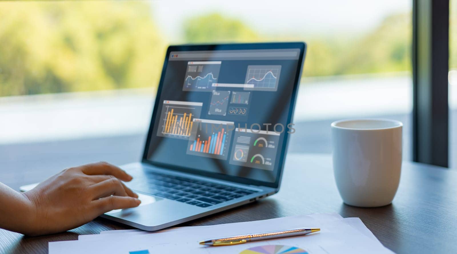 Business woman show laptop to analyze business and manage corporate data, Business analytics with charts, metrics and KPIs to improve organizational performance, Marketing and financial strategy.