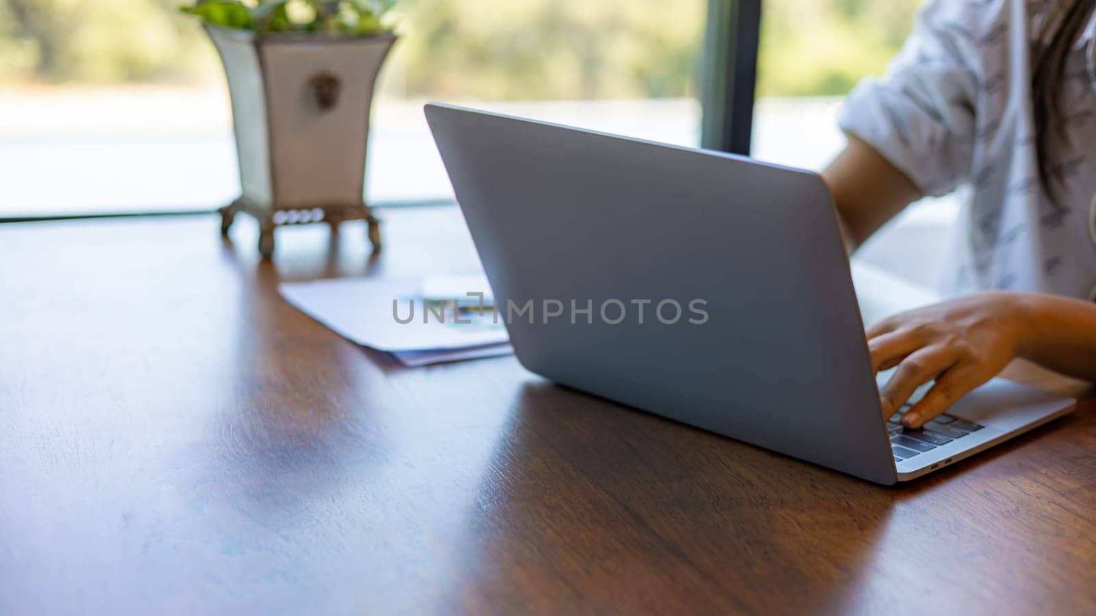Business woman working from home using laptop online meeting in home office, Closeup image of a woman working and typing on laptop computer keyboard on the table.