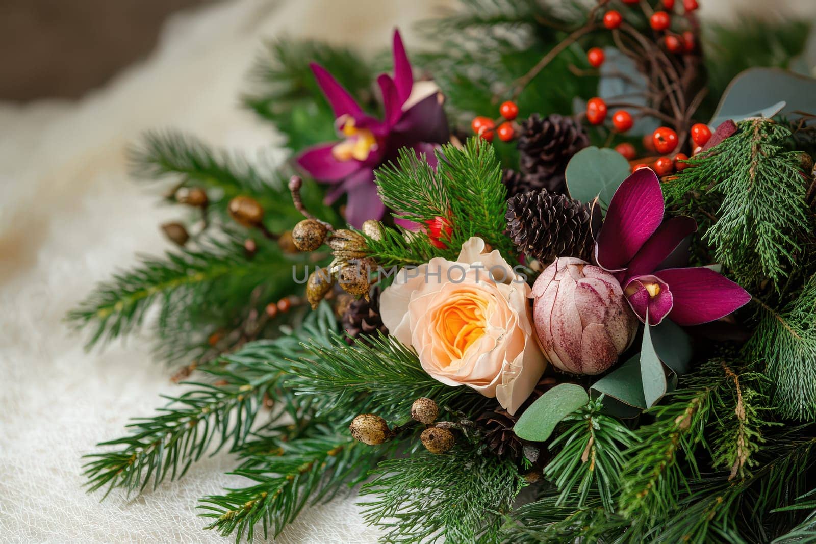 A beautiful arrangement of fresh flowers and greenery with ornaments and berries perfect for celebrating the Christmas season.