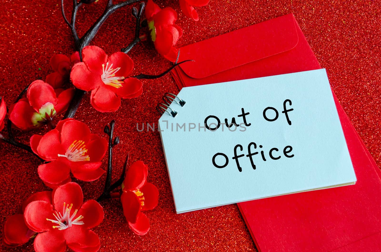 Top view of Out Of Office text with Chinese New Year decoration. Copy space and Chinese New Year celebration